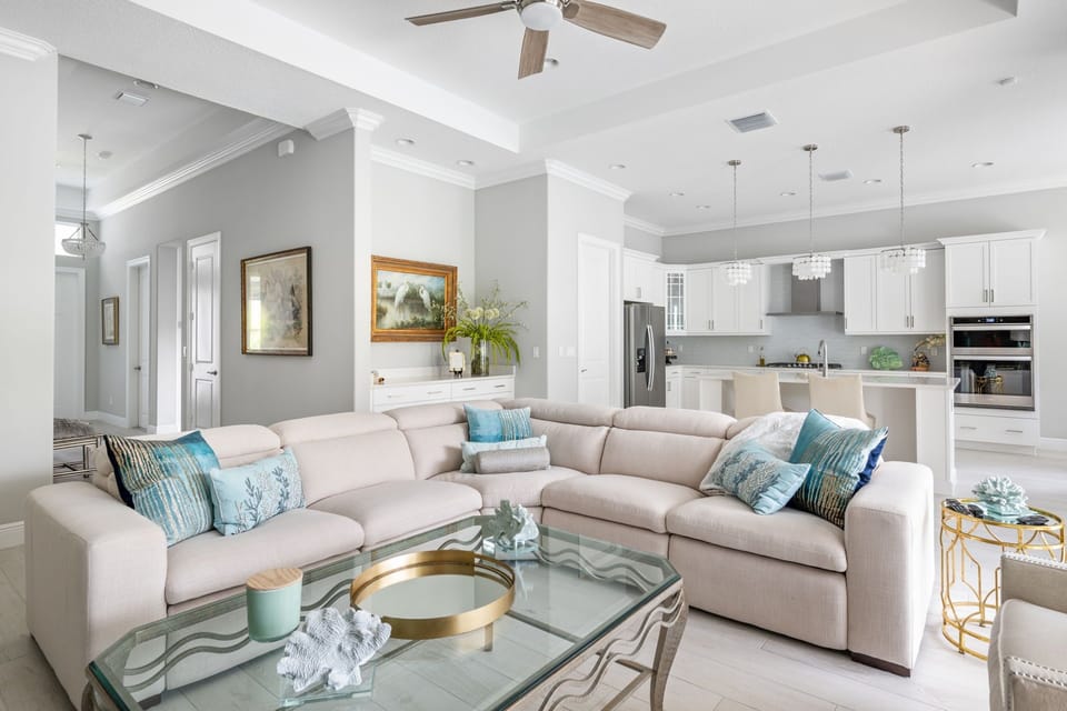 The living room is the perfect spot to unwind after a long day. Admire the view of the pool while watching TV or lounging on the reclining  couch.       