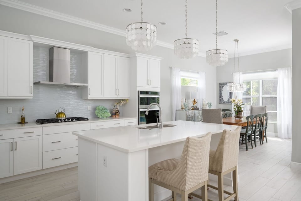 The sleek white cabinets in this kitchen provide a modern touch to the space. With a fully stocked kitchen and major appliances, it has everything you need for a comfortable stay and to make some delicious meals.