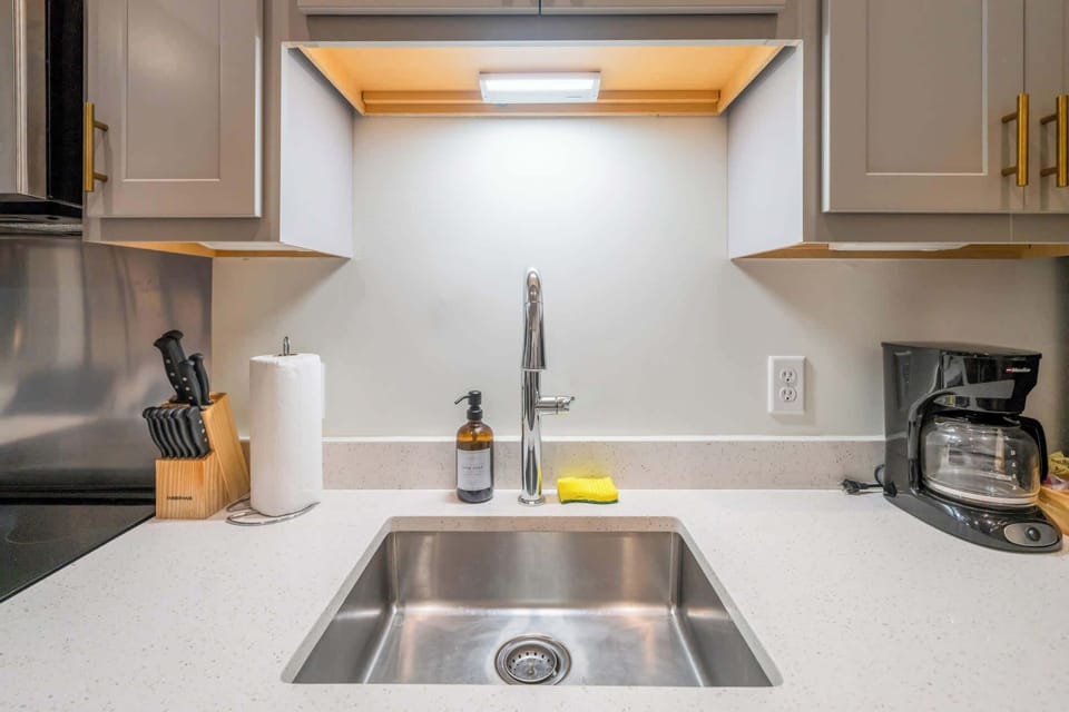 Kitchen: Modern kitchen with sleek stainless-steel appliances and ample counter space, plus a dining area good for four.