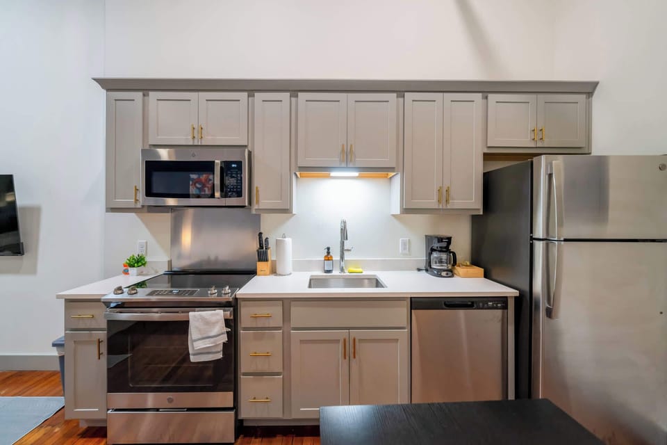 Kitchen: Modern kitchen with sleek stainless-steel appliances and ample counter space, plus a dining area good for four.