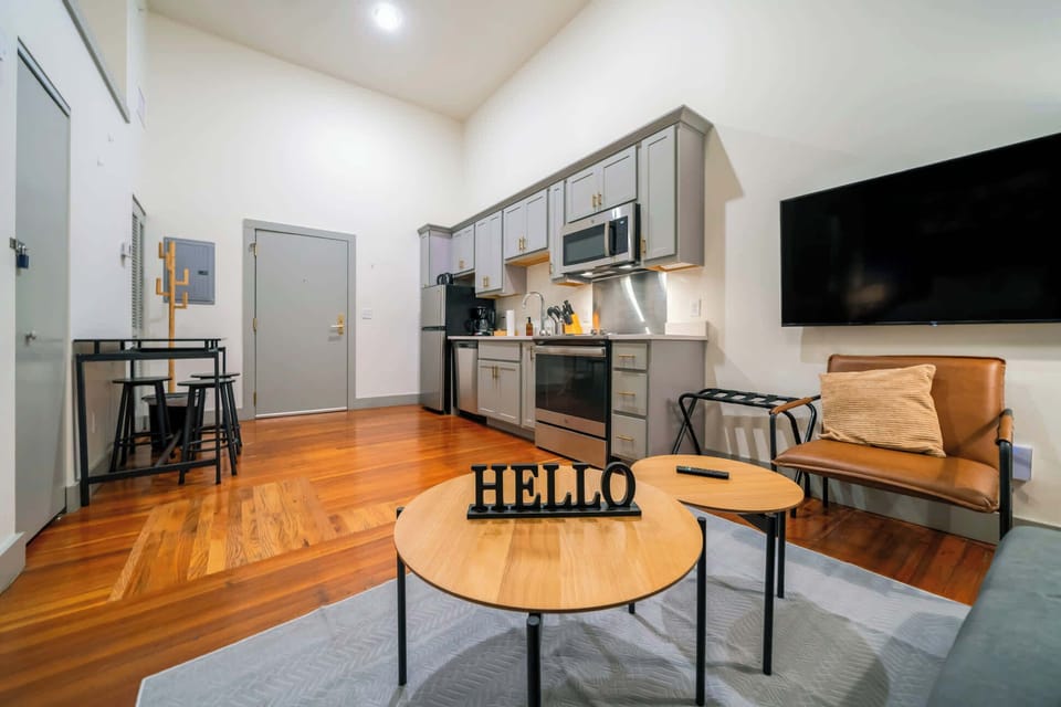 Living Room: Bright and open living area with modern kitchen, perfect for entertaining or relaxing after a long day.