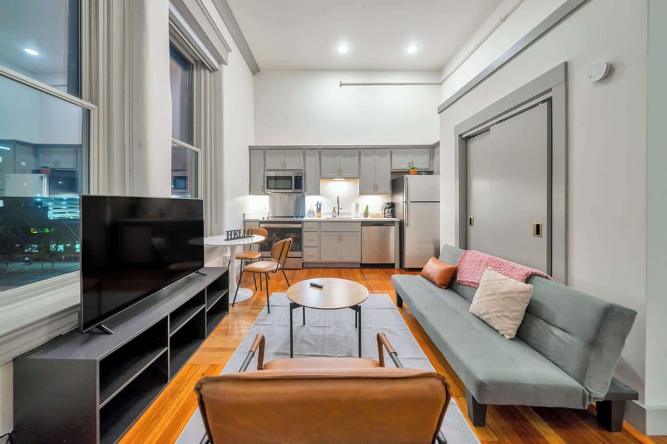 Living Room: Bright and open living area with high ceilings, comfortable seating, and stylish decor—ideal for relaxing or entertaining.