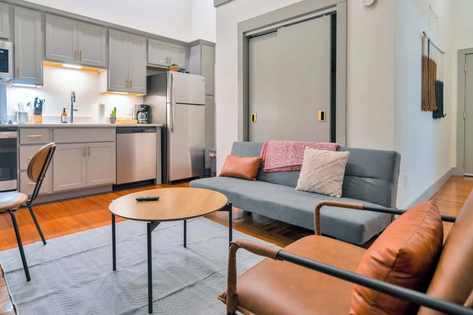 Living Room: Bright and open living area with high ceilings, comfortable seating, and stylish decor—ideal for relaxing or entertaining.