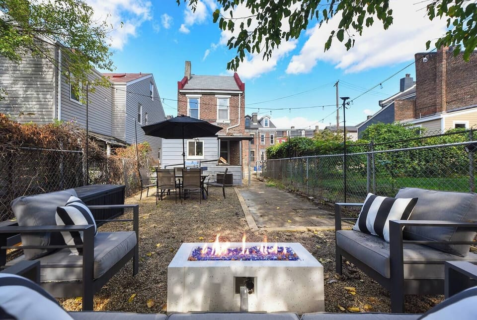 Cozy backyard with fireplace, barbecue, dining area and bar