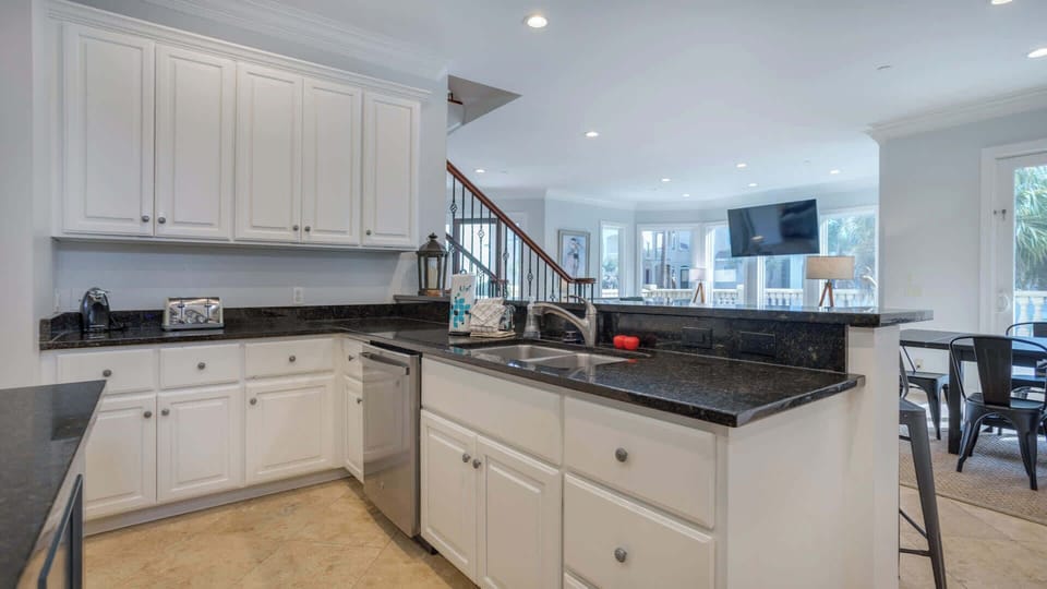 Experience the joy of cooking in this beautifully designed kitchen, complete with high-end appliances and generous counter space. The inviting bar seating creates a social atmosphere, making it easy to host gatherings while whipping up your favs!