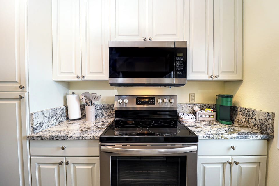 Kitchen w/ Electric Stovetop and Microwave