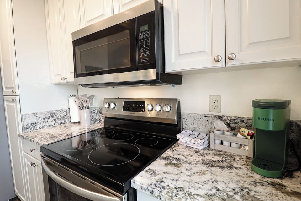 Kitchen w/ Electric stovetop and Microwave