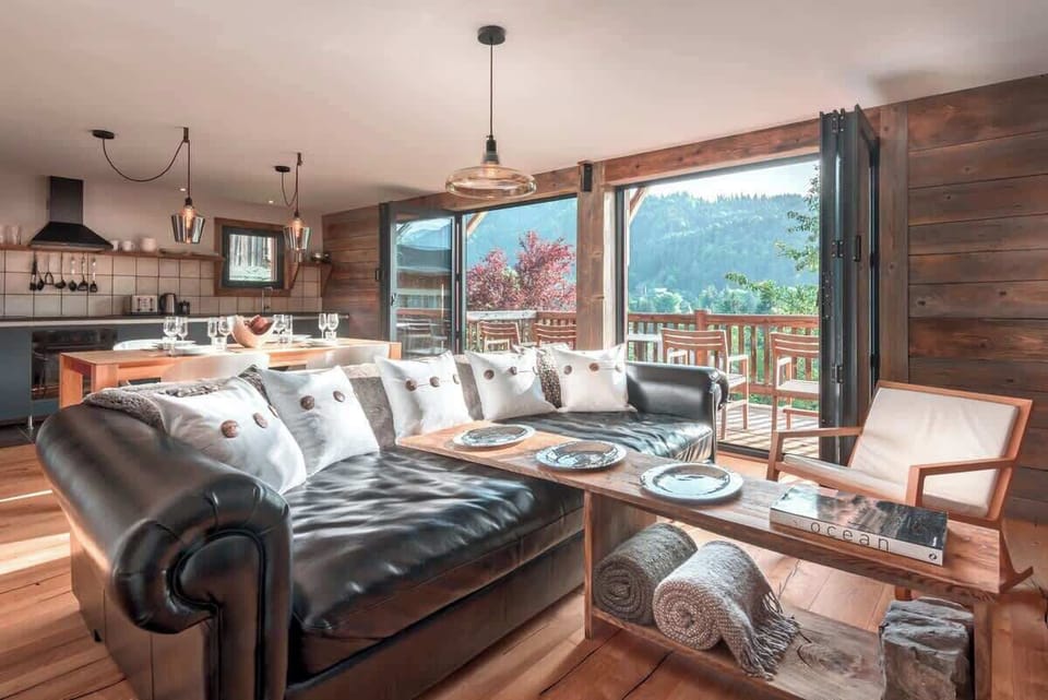 Second living area on lower level with bi-folding doors opening on to a large, south facing private balcony.