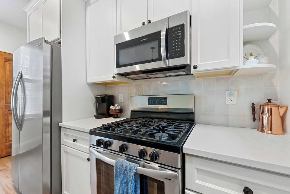 The chic kitchen offers ample space & all the comforts of home