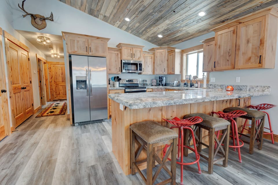 Spacious kitchen with large island and bar seating, perfect for gathering.
