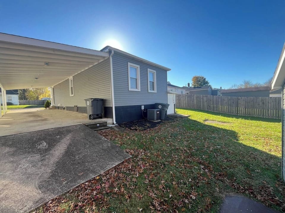 Enjoy a spacious yard perfect for gatherings and shaded parking in Evansville.