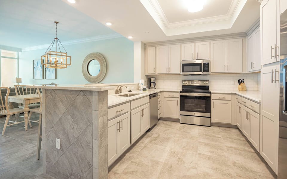 Prepare meals in this kitchen with elegant cabinetry, stainless appliances, and spacious countertops