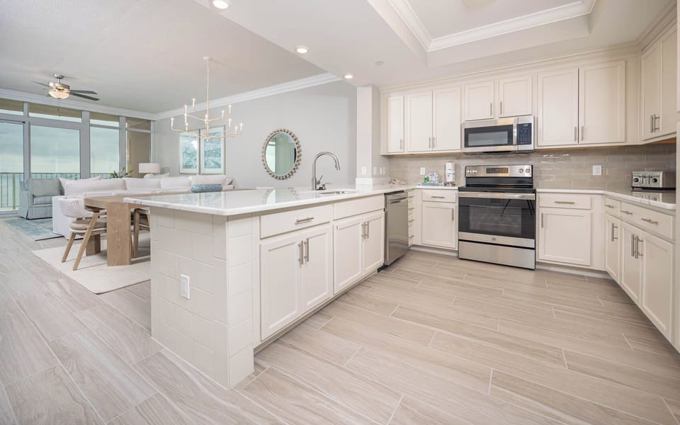 Prepare meals in this kitchen with elegant cabinetry, stainless appliances, and spacious countertops