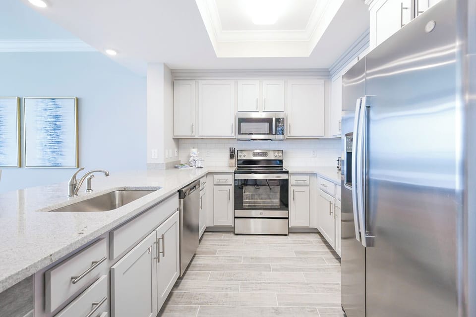 Prepare meals in this kitchen with elegant cabinetry, stainless appliances, and spacious countertops
