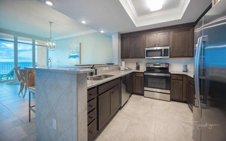 Prepare meals in this kitchen with elegant cabinetry, stainless appliances, and spacious countertops
