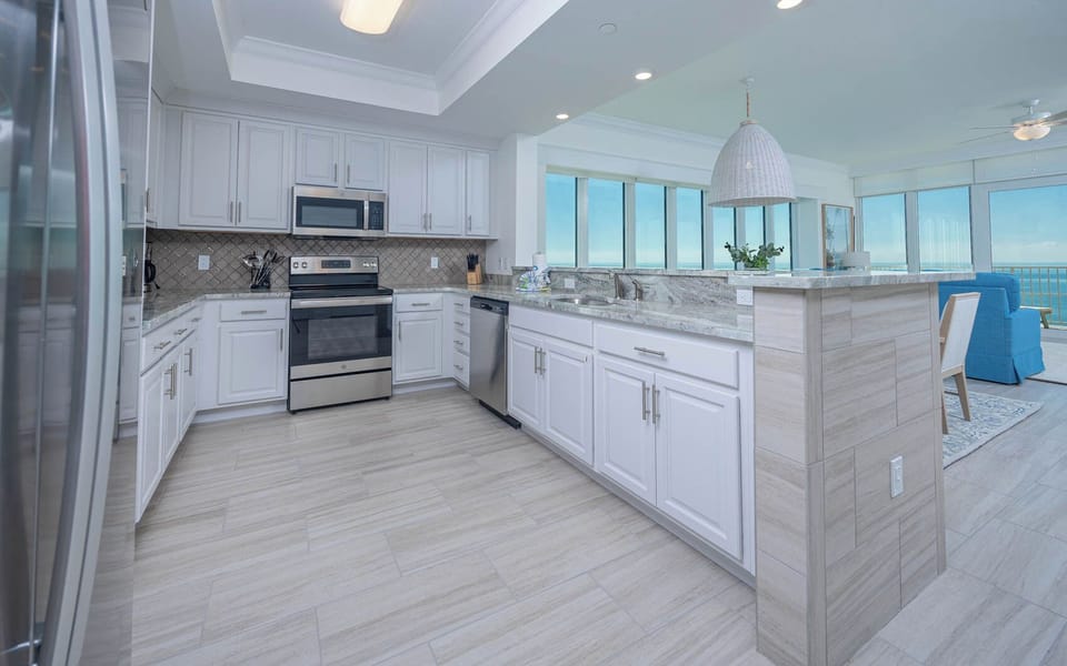 Prepare meals in this kitchen with elegant cabinetry, stainless appliances, and spacious countertops