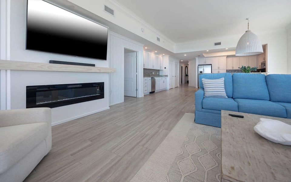 Curl up on the blue couch and stream your favorite shows on the wall TV above the sleek fireplace