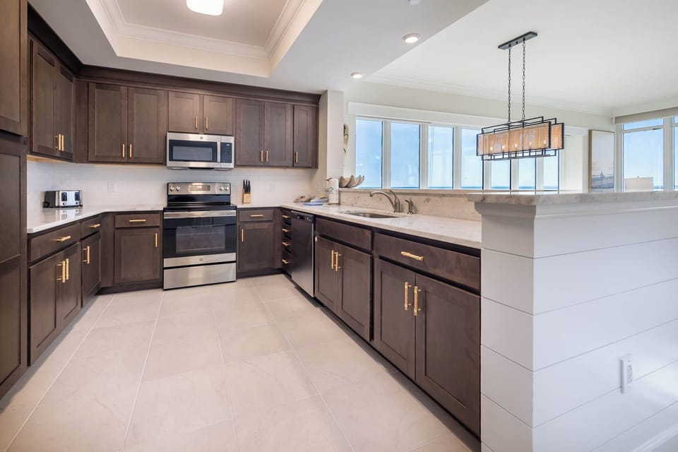 Prepare meals in this kitchen with elegant cabinetry, stainless appliances, and spacious countertops