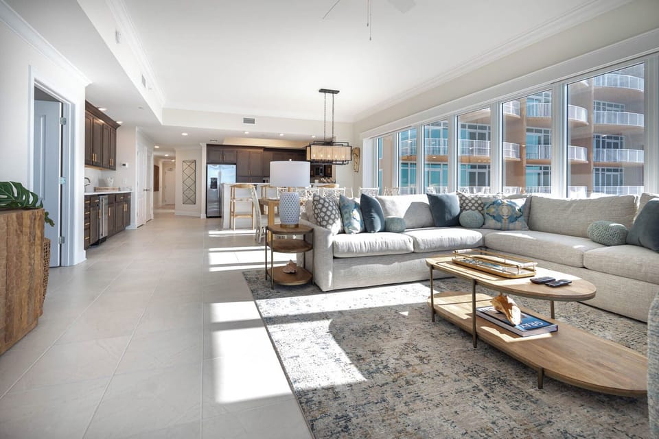 Gather in this welcoming living space and enjoy stunning panoramic beach views through the windows