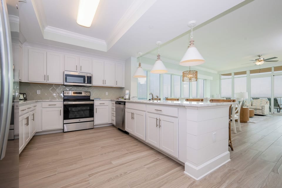 Prepare meals in this kitchen with elegant cabinetry, stainless appliances, and spacious countertops