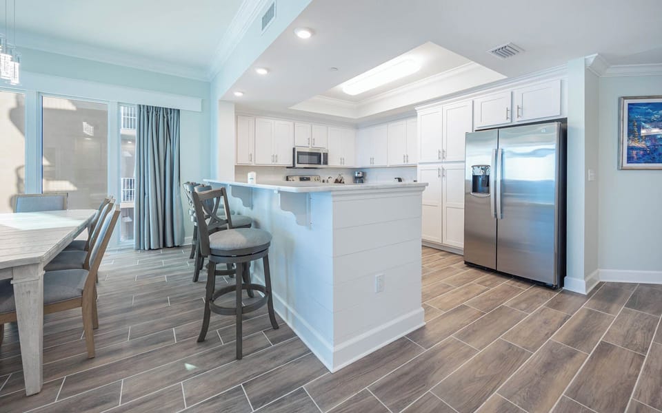 Sip your morning coffee at the breakfast bar and get ready for a beach day in this stylish space
