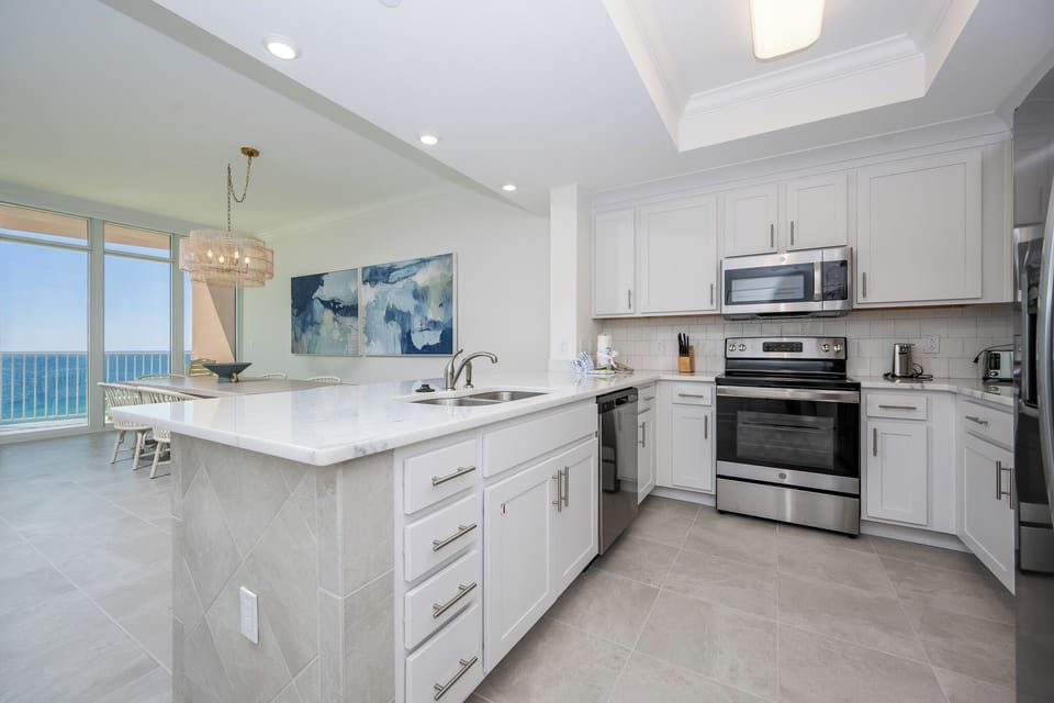 Prepare meals in this kitchen with elegant cabinetry, stainless appliances, and spacious countertops