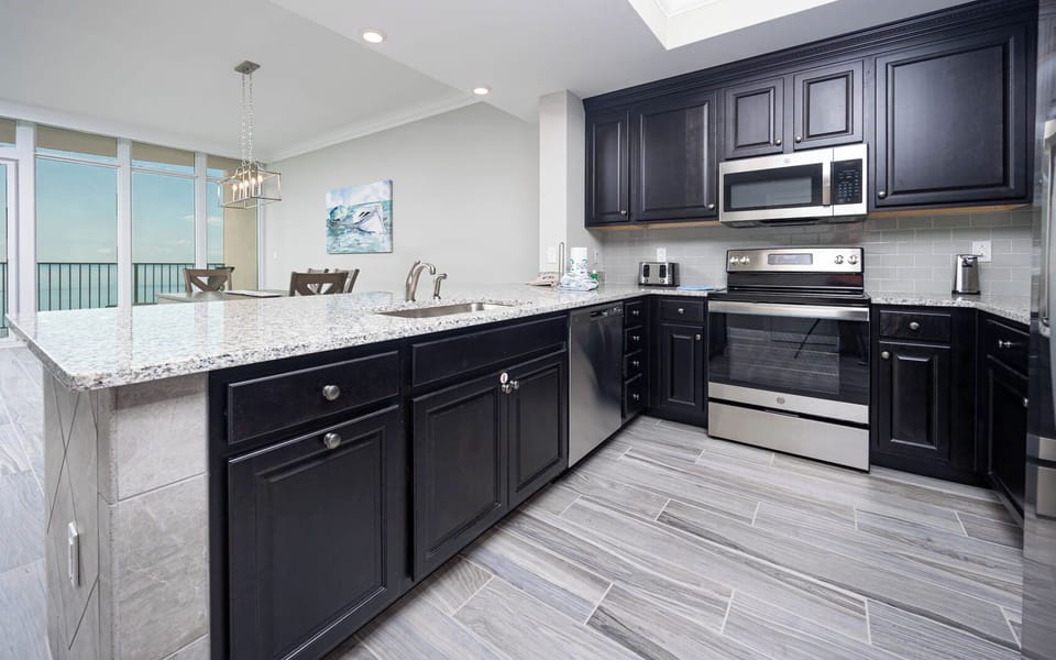 Prepare meals in this kitchen with elegant cabinetry, stainless appliances, and spacious countertops