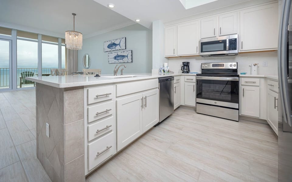 Prepare meals in this kitchen with elegant cabinetry, stainless appliances, and spacious countertops