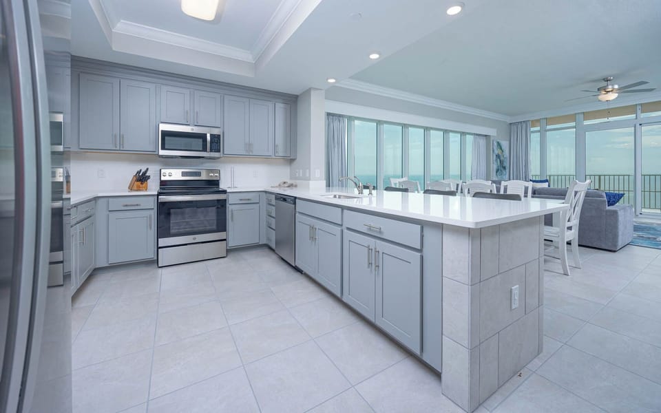 Prepare meals in this kitchen with elegant cabinetry, stainless appliances, and spacious countertops