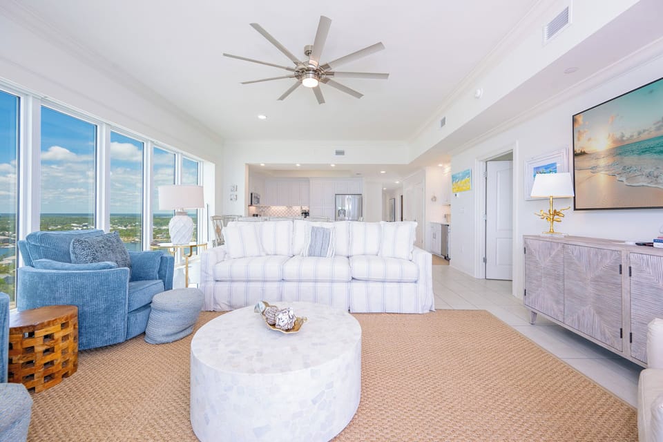 Blue chairs in the living room welcome you to talk and laugh while city views stretch beyond your windows