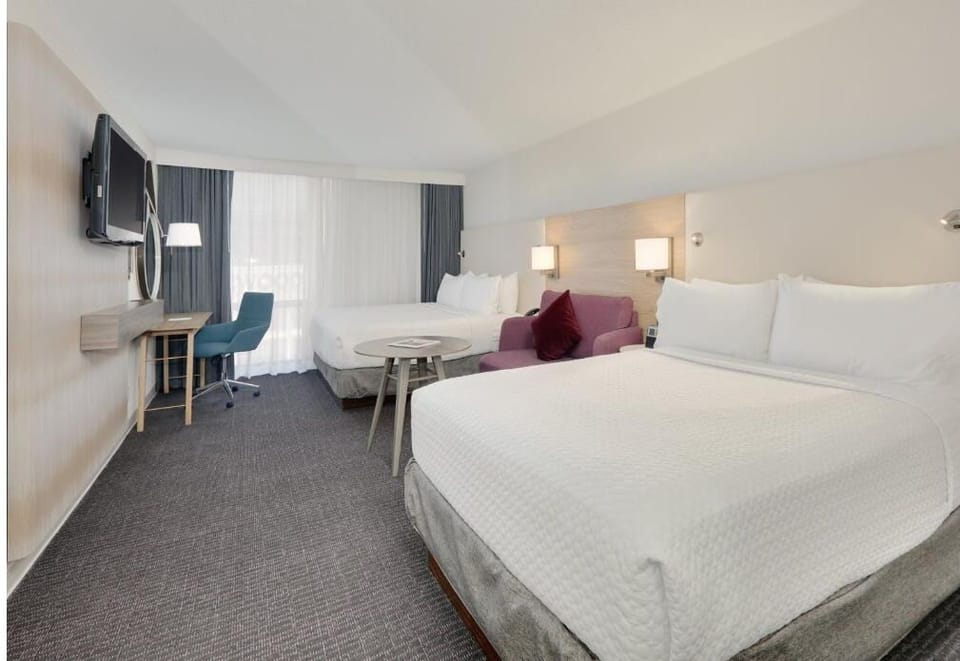 Unwind on the cozy loveseat between crisp, cloud-soft beds.
