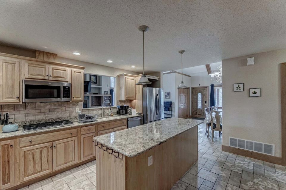 Full size kitchen with large island and stainless steel appliances
