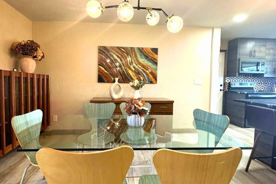 We have a glass dining table that accommodates six guests.