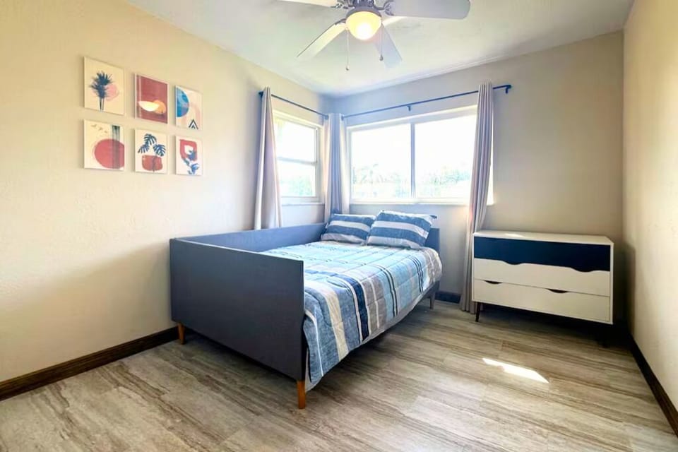 The third bedroom includes a full-size daybed, a dresser, ceiling fan and closet
