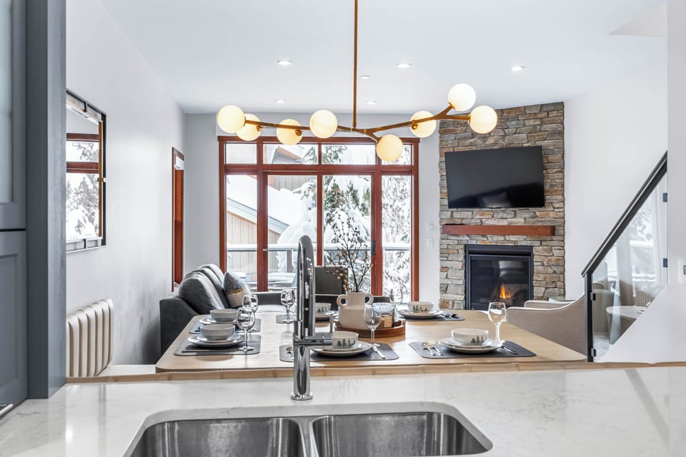 The living room has a 55" Smart TV and plenty of natural light, highlighting the modern furnishings. A very inviting space to sit back and relax. 
