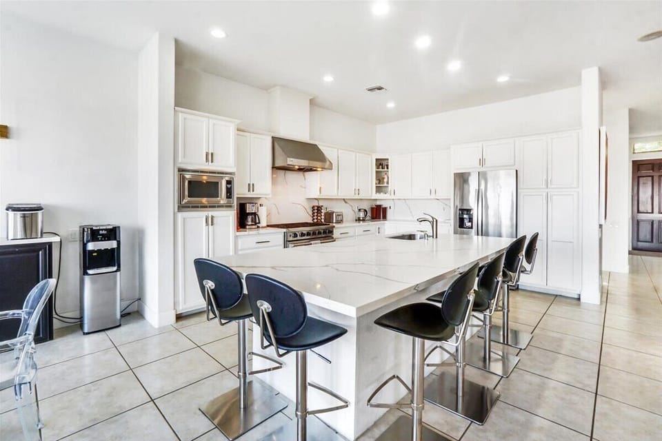 Kitchen/Breakfast Bar - With its sleek countertop and comfortable seating.