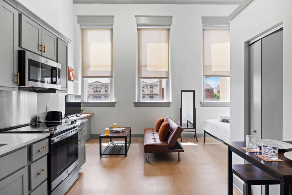 Living Room: Bright and open living area with high ceilings, comfortable seating, and stylish decor—ideal for relaxing or entertaining.