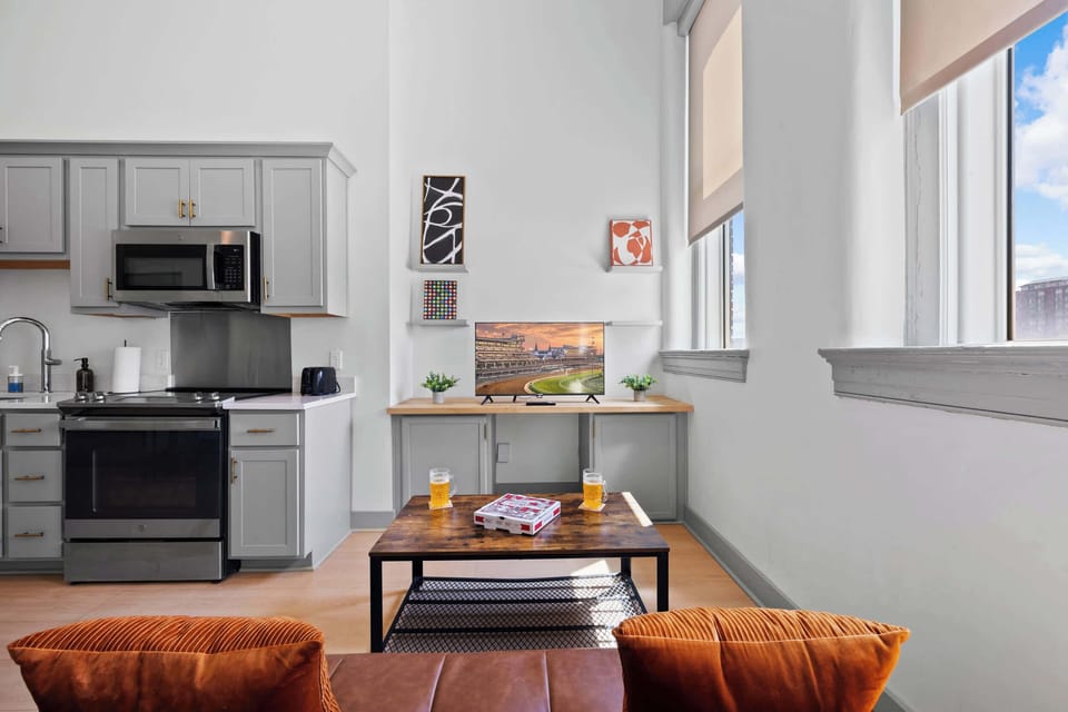 Living Room: Bright and open living area with high ceilings, comfortable seating, and stylish decor—ideal for relaxing or entertaining.