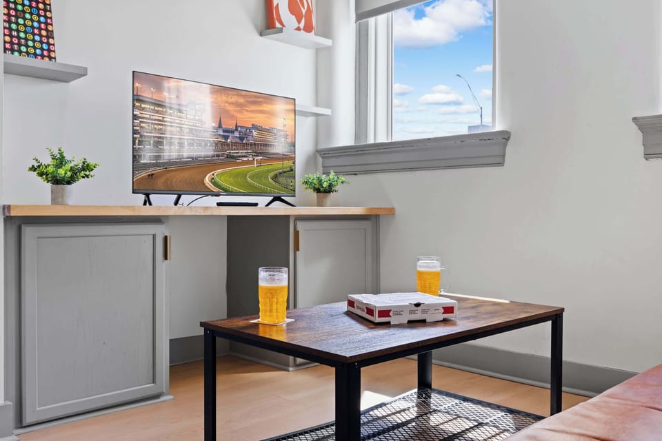 Living Room: Bright and open living area with high ceilings, comfortable seating, and stylish decor—ideal for relaxing or entertaining.