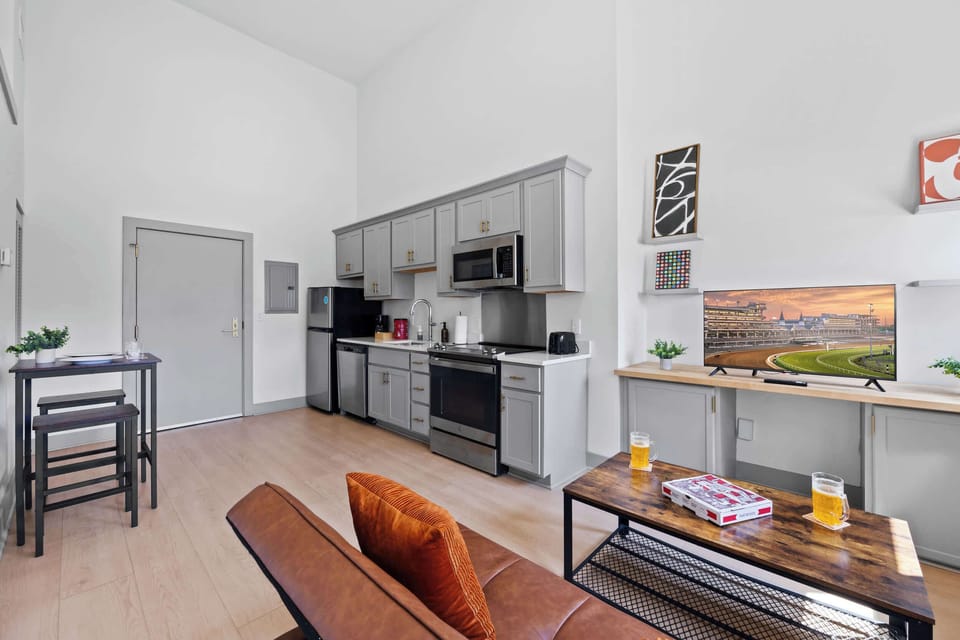 Living Room: Bright and open living area with high ceilings, comfortable seating, and stylish decor—ideal for relaxing or entertaining.