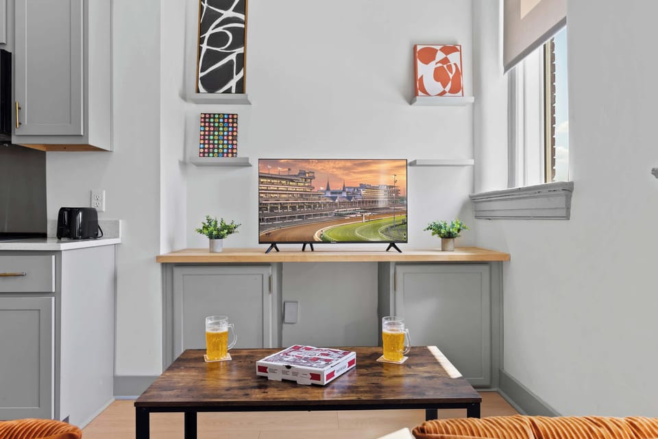 Living Room: Bright and open living area with high ceilings, comfortable seating, and stylish decor—ideal for relaxing or entertaining.