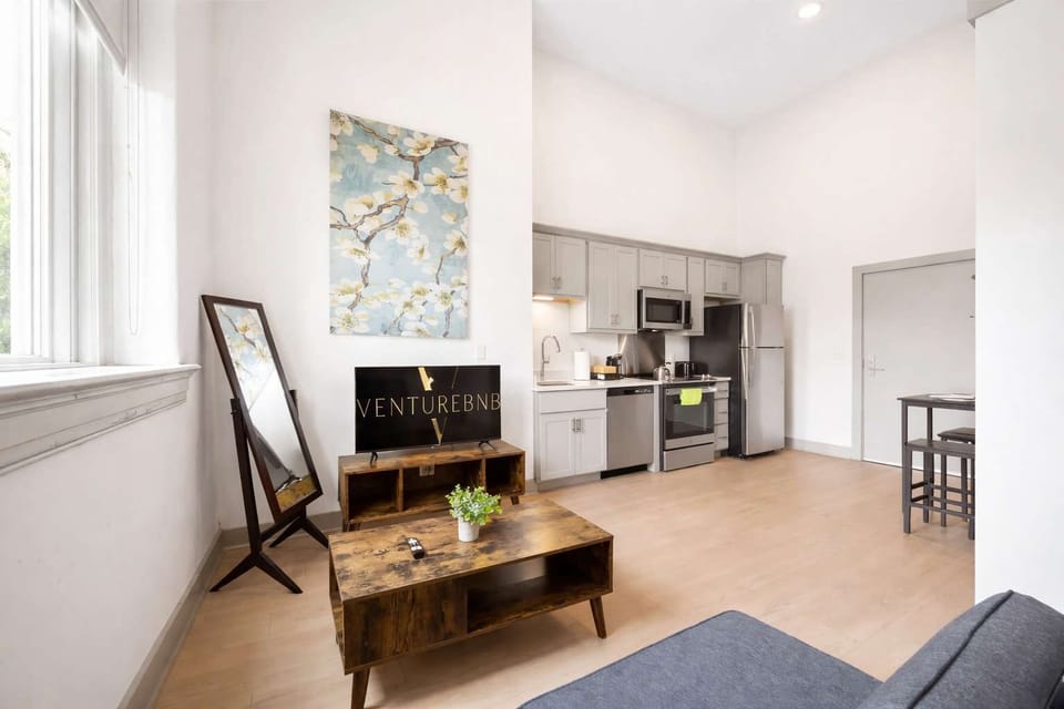Living Room: Bright and open living area with high ceilings, comfortable seating, and stylish decor—ideal for relaxing or entertaining.