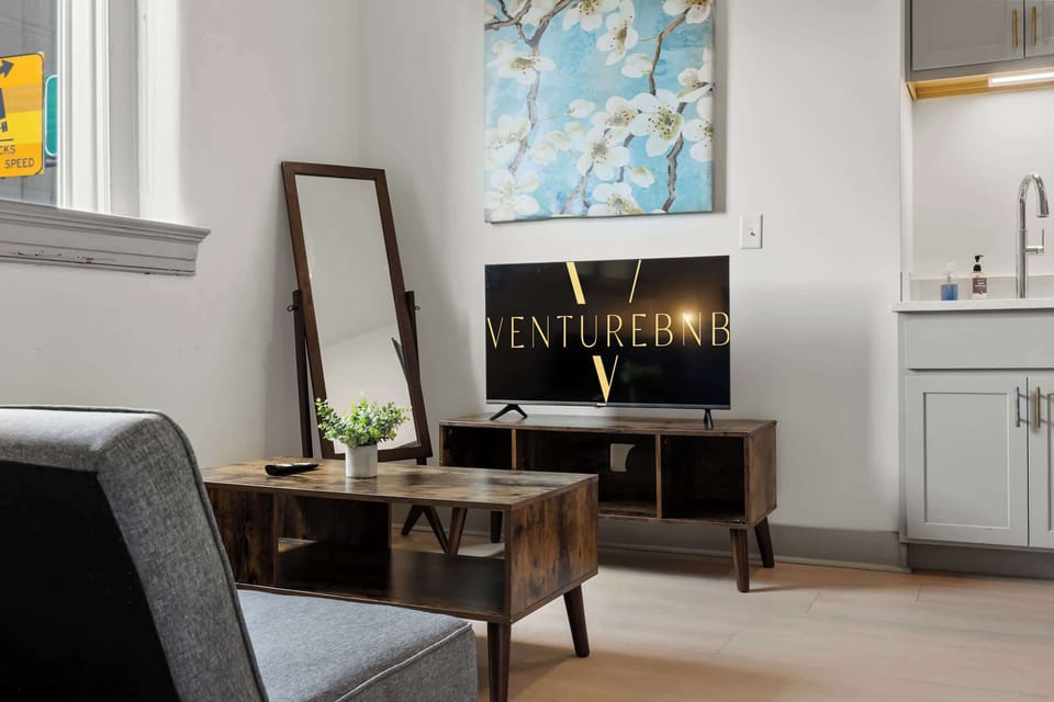 Living Room: Bright and open living area with high ceilings, comfortable seating, and stylish decor—ideal for relaxing or entertaining.