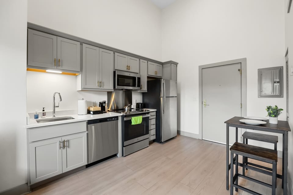 Kitchen: Modern kitchen with sleek stainless-steel appliances, a cozy dining area and ample counter space.