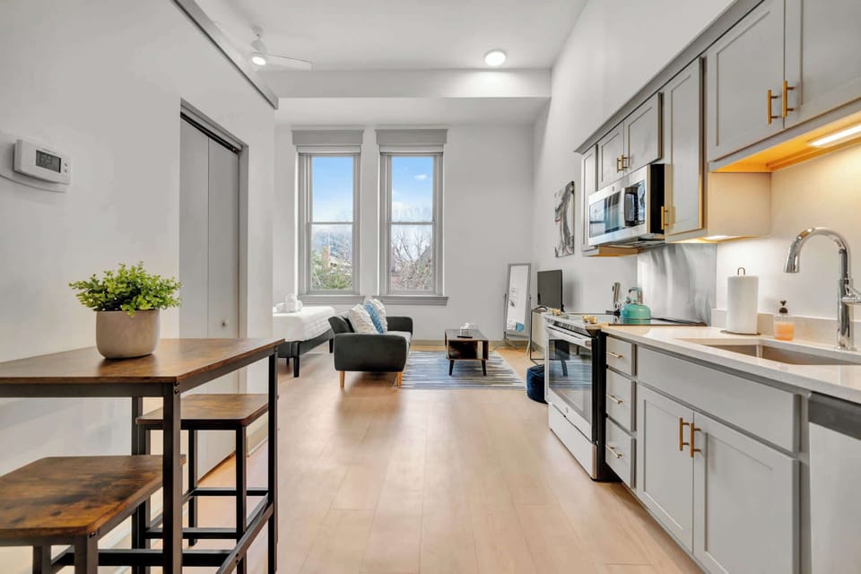Living Room: Bright and open living area with high ceilings, comfortable seating, and stylish decor—ideal for relaxing or entertaining.