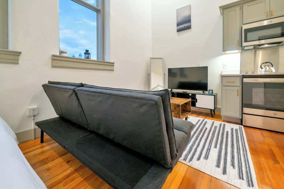 Living Room: Bright and open living area with high ceilings, comfortable seating, and stylish decor—ideal for relaxing or entertaining.