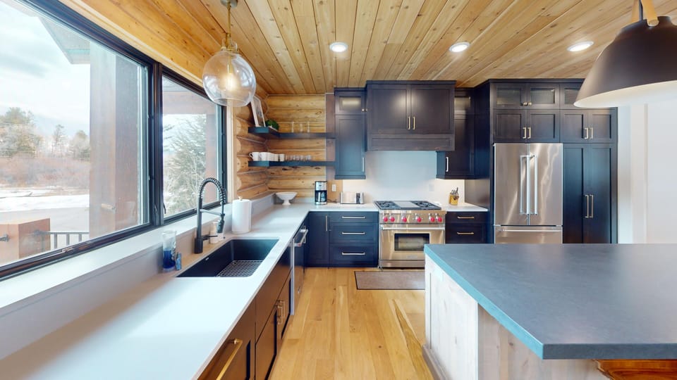Your gourmet kitchen awaits with sleek counters, stainless appliances, and warm wood touches creating the perfect space for memorable meals.