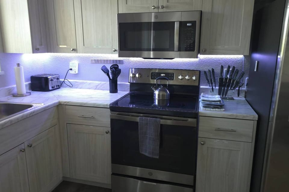 All your cooking amenities with a stainless-steel microwave and stove