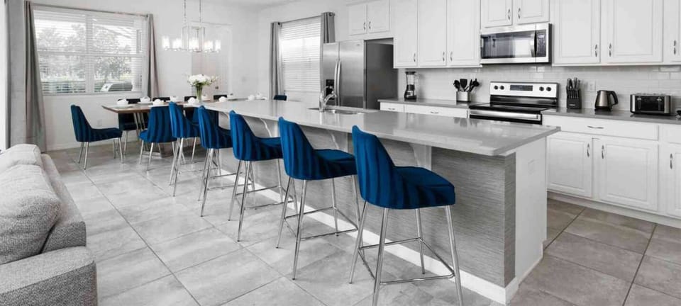 Spacious kitchen with all the essentials and seats in front for a casual dining experience.