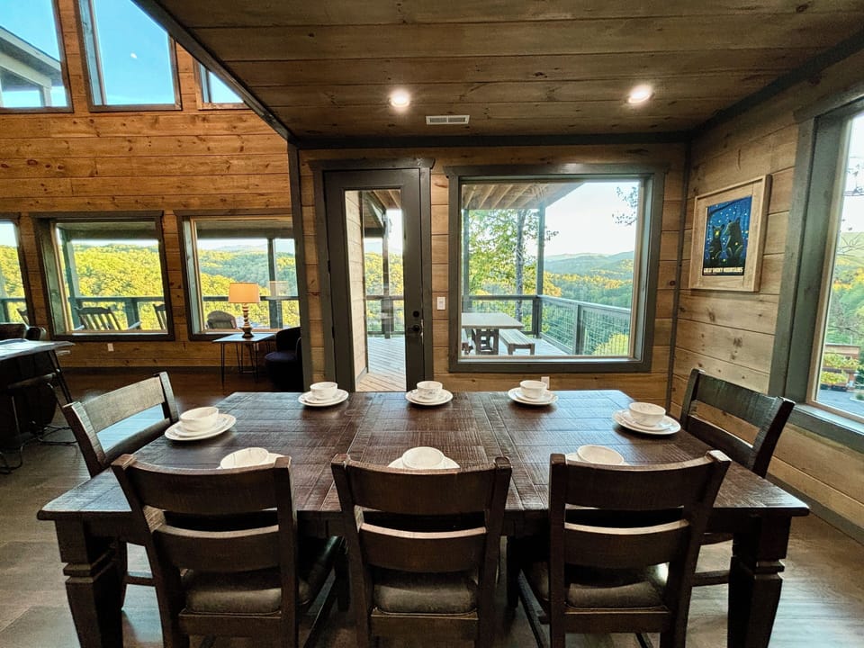 Enjoy mountain-view dining in this cozy rustic cabin, warm wood interior.